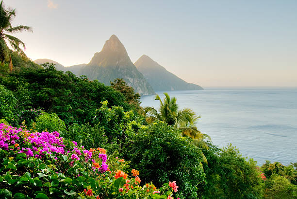 The peaks of St. Lucia's Twin Pitons are lit by the sunrise glow.