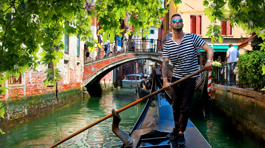 Venice canal at golden hour, gondolier steering a sleek gondola