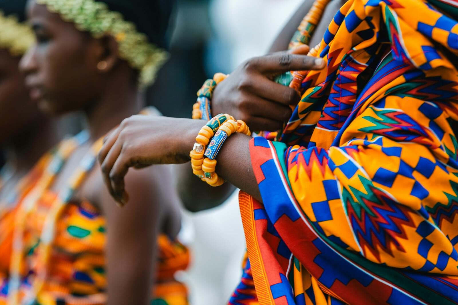 Colorful cultural attire and jewelry at a vibrant festival in Accra, Ghana.